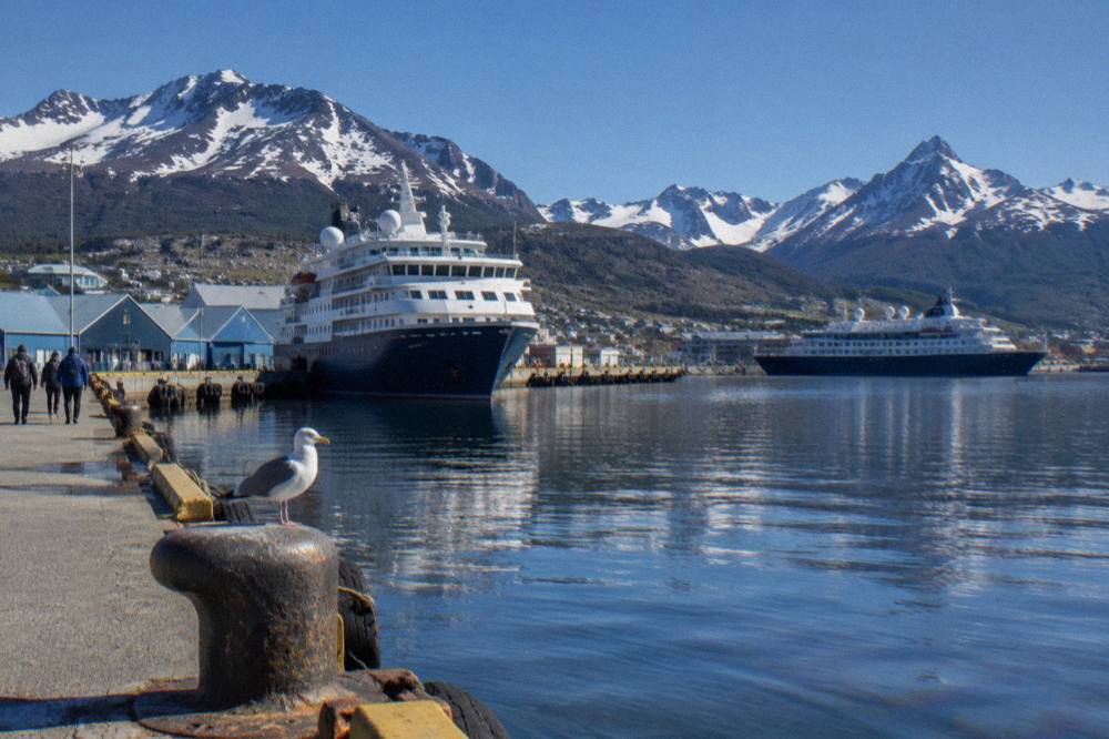 Ushuaia's waterfront and cruise terminal with expedition ships moored along the Beagle Channel