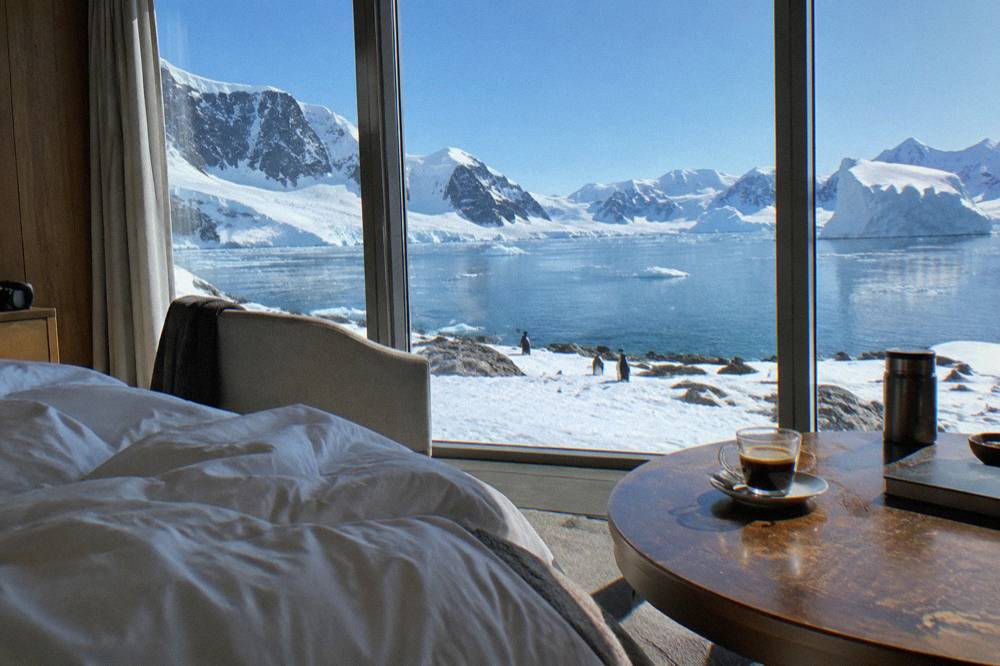 Elegant suite interior with large windows and ice visible beyond the glass