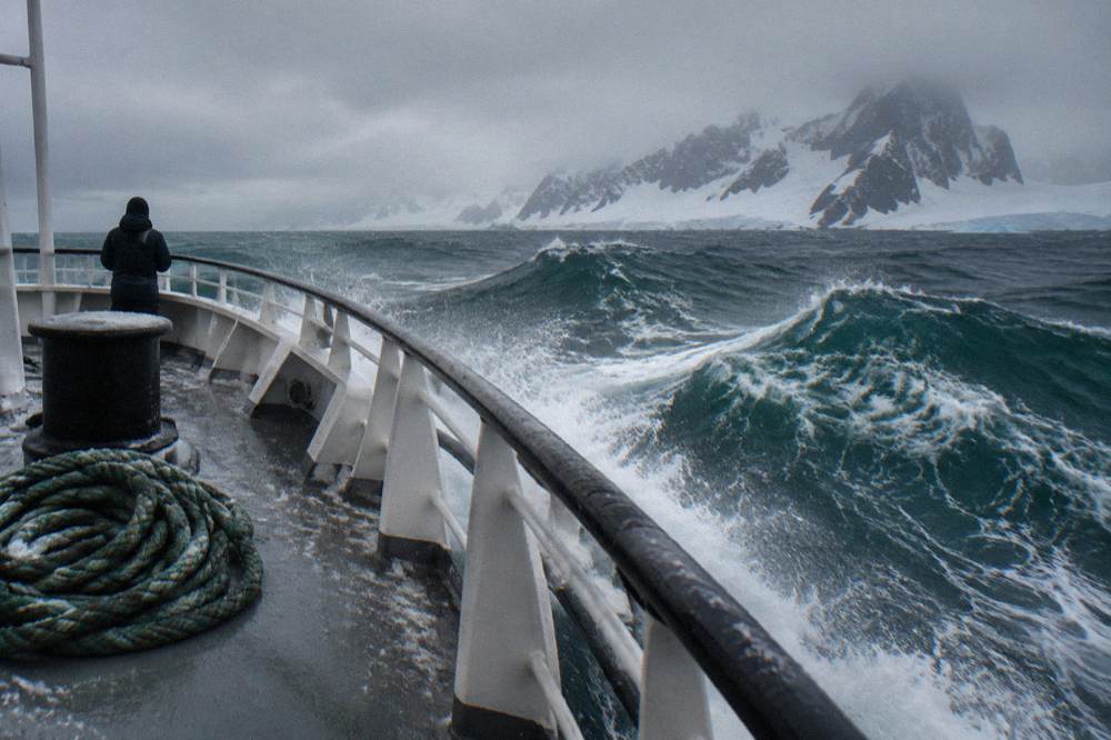 Open ocean swells seen from the bow of an expedition ship mid-crossing
