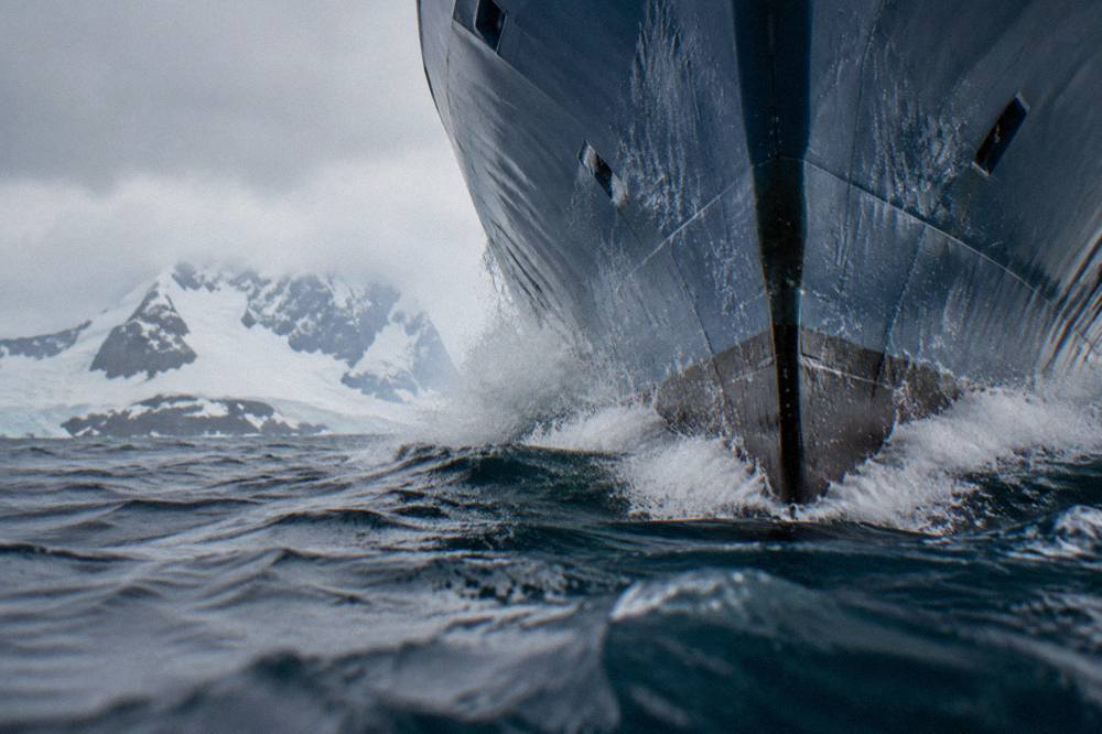 Inverted X-BOW bow of an expedition ship cutting through open ocean swell