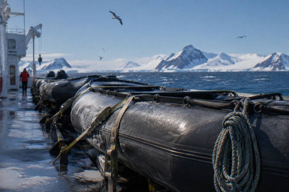 Zodiacs lined up on the deck of an expedition ship in Antarctic waters