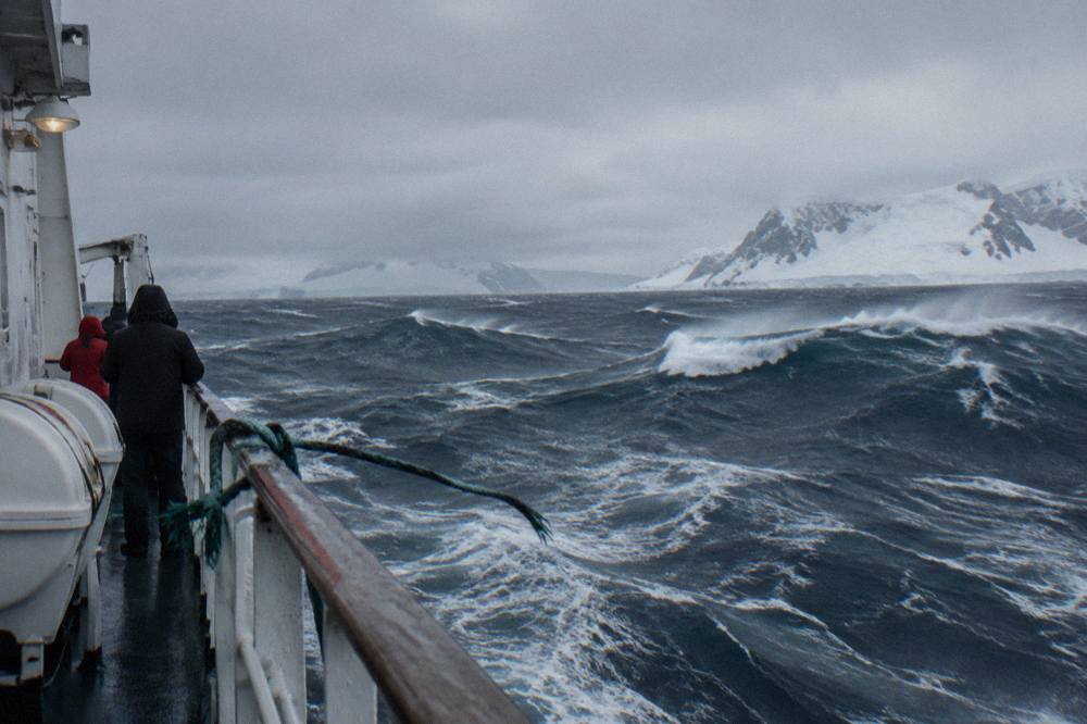 Heavy ocean swell with whitecaps under a grey sky in open Southern Ocean water