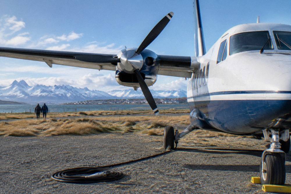 A twin-engine charter aircraft on a gravel runway in southern Patagonia before an Antarctic flight