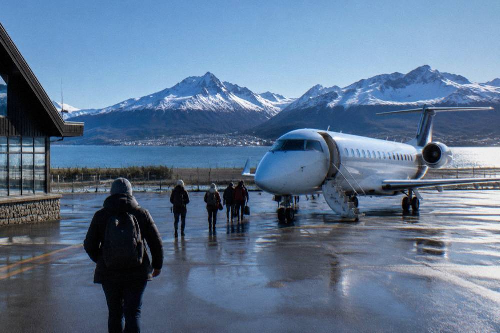 Aircraft on the runway at Ushuaia airport with the Beagle Channel and mountains in the background
